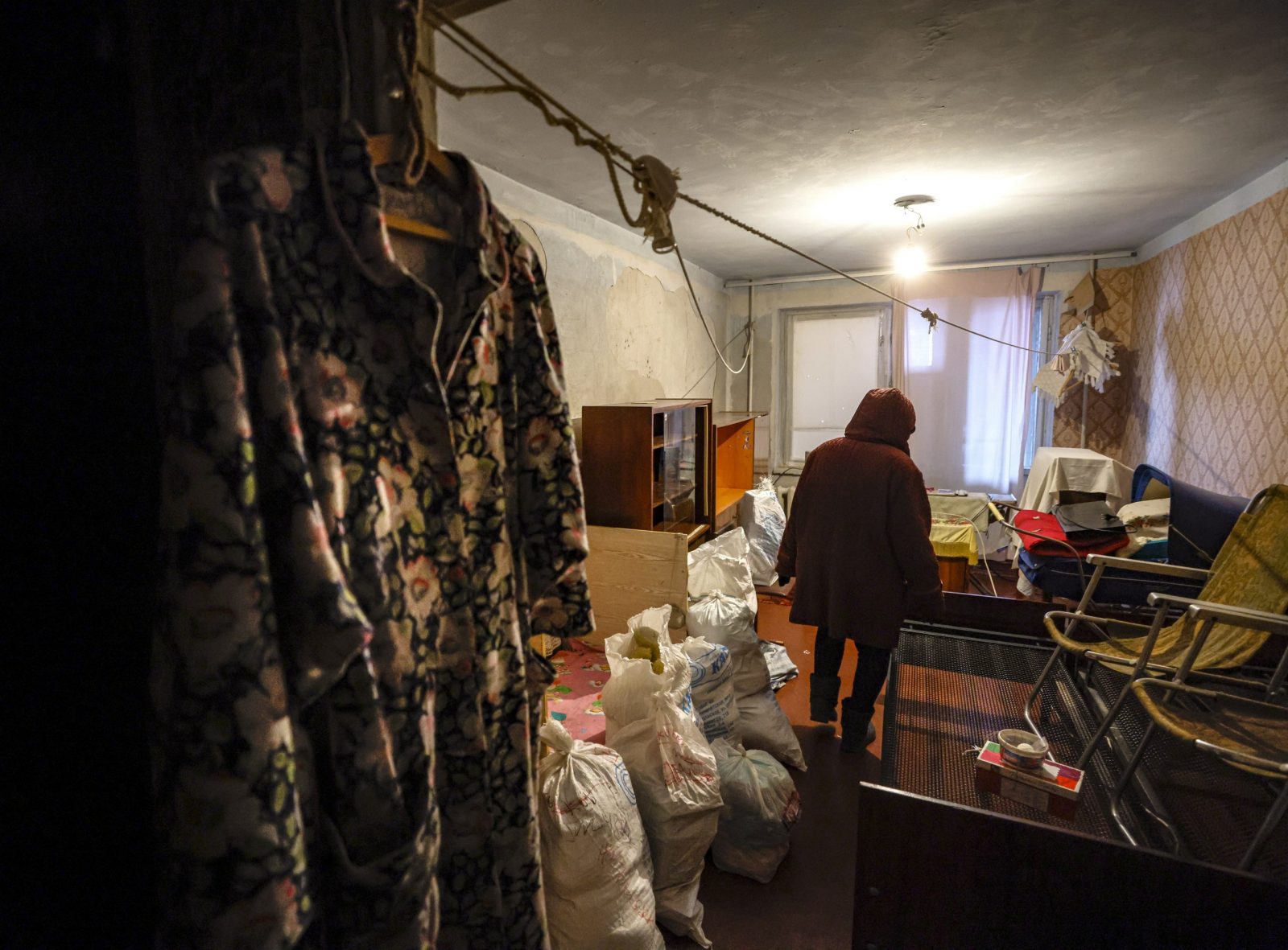 epa10354587 Mariupol resident, 76 years old Lidia, gathers goods and personal possessions before moving out of her apartment at a damaged building in Mariupol, Ukraine, 07 December 2022 (Issued 08 December 2022). Mariupol had seen a long battle for its control between the Ukrainian forces and the Russian army and Russian backed self proclaimed Donetsk People’s Republic (DPR) as well as a siege, the hostilities lasted from February to the end of May 2022 killing thousands of people and destroying most of the city in the process. A ccording to the DPR government which took control after May 2022, more than five thousand builders are currently working in Mariupol, they expect the city to be completely rebuilt in a three years time.  EPA/SERGEI ILNITSKY