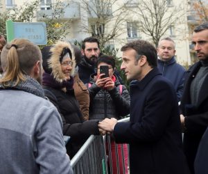 epa10355098 French President Emmanuel Macron (C) shakes hand with people as he arrives to attend a territorial session of the National Council for Refoundation on health (CNR) in Fontaine-le-Comte, near Poitiers, France 08 December 2022.  EPA/Teresa Suarez / POOL