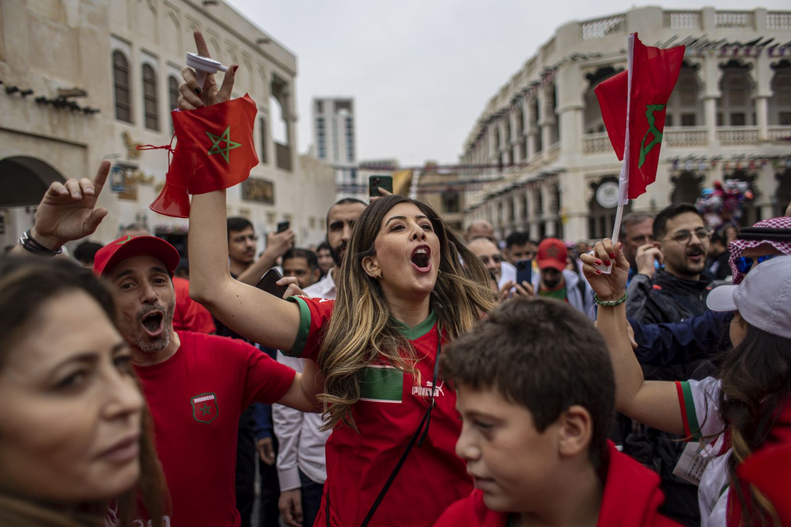 epa10358817 Fans of Morocco cheer at the Souq Waqif market during FIFA World Cup 2022 in Doha, Qatar, 10 December 2022. Morocco will face Portugal in their FIFA World Cup 2022 quarter final soccer match on 10 December 2022.  EPA/MARTIN DIVISEK