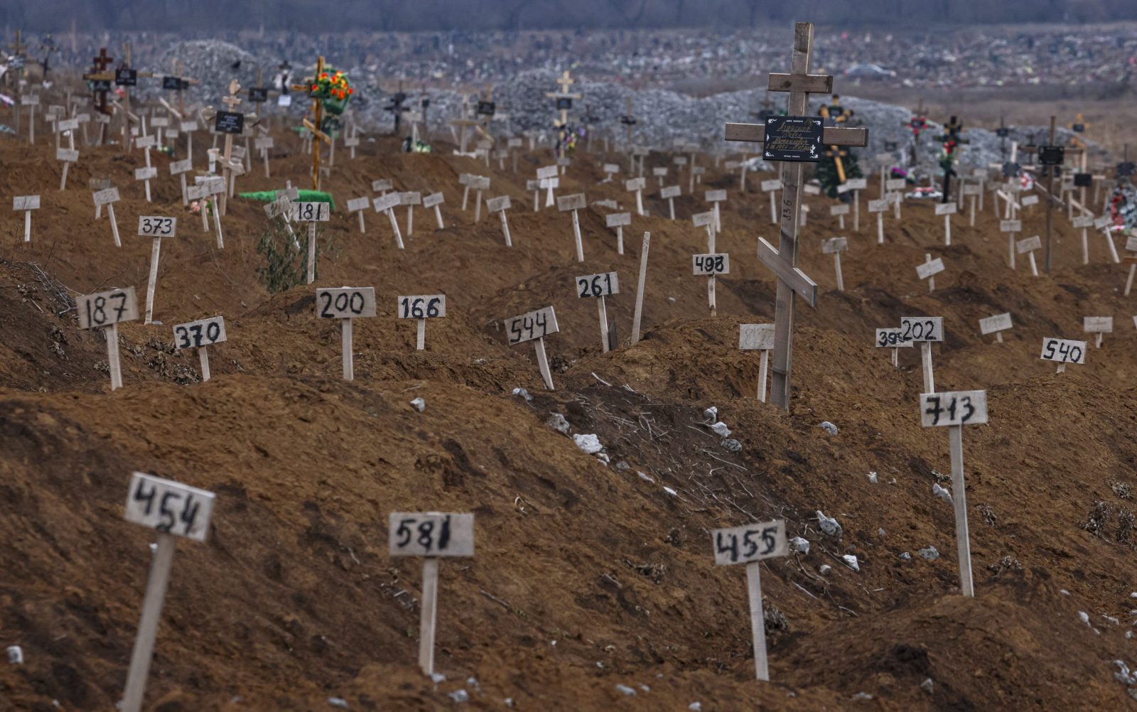 epa10360629 Numbers mark the graves of unidentified local residents who were killed during fights in the city on the cemetery in Mariupol, Ukraine, 10 December 2022 (issued 11 December 2022). An estimate 250,000 inhabitants have left the city, about 300,000 still remain. During the hostilities, up to 70 percent of the housing stock of Mariupol was destroyed and about 5,000 civilians were killed due to fighting and shelling, Konstantin Ivashchenko, the new mayor of the city, said. City authorities prepare residential buildings for winter and change all central heating systems in Mariupol, where by the end of the year at least 1,000 residential buildings, social and cultural facilities will be connected to heat, said Russian Deputy Prime Minister Marat Khusnullin. The government of the self-proclaimed Donetsk People's Republic (DPR) reported that 129,000 square meters of new housing will appear next year in Mariupol. More than 5,000 builders are working on the restoration of the city. Mariupol is expected to be completely rebuilt in three years.  EPA/SERGEI ILNITSKY