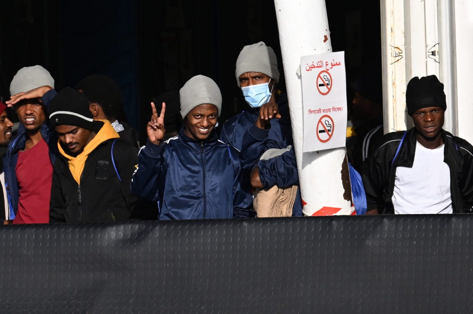 epa10360703 Migrants, among 248 migrants on board Ship Geo Barents, look on upon arrival at Salerno's harbor, southeast of Naples, Italy, 11 December 2022. Migrant rescue ship Geo Barents, operated by the Doctors Without Borders (MSF) organization, was allowed to dock at Salerno port to disembark the 248 survivors currently on board, including women and children, the NGO said.  EPA/Massimo Pica ITALY OUT