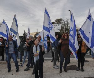 epa10362147 Israelis holding flags during a demonstration against the government of Benjamin Netanyahu, which he seeks to form, as they block the entrance of the Israeli Knesset, in Jerusalem, 12 December 2022.  EPA/ATEF SAFADI