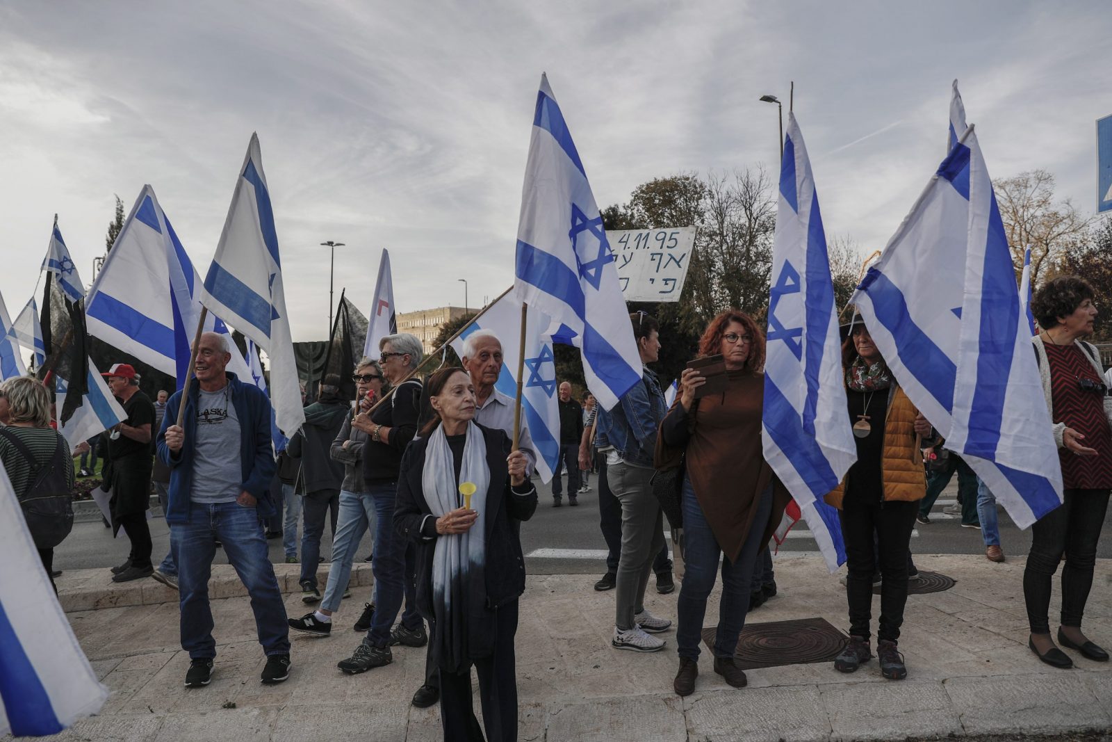 epa10362147 Israelis holding flags during a demonstration against the government of Benjamin Netanyahu, which he seeks to form, as they block the entrance of the Israeli Knesset, in Jerusalem, 12 December 2022.  EPA/ATEF SAFADI