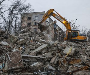 epa10362469 An excavator cleans debris of a destroyed building in downtown of Mariupol, Ukraine, 12 December 2022. Mariupol had seen a long battle for its control between the Ukrainian forces and the Russian army and Russian backed separatist Donetsk People’s Republic (DPR) as well as a siege, the hostilities lasted from February to the end of May 2022 killing thousands of people and destroying most of the city in the process. According to the DPR government which took control after May 2022, more than five thousand builders are currently working in Mariupol, they expect the city to be completely rebuilt in three years' time.  EPA/SERGEI ILNITSKY