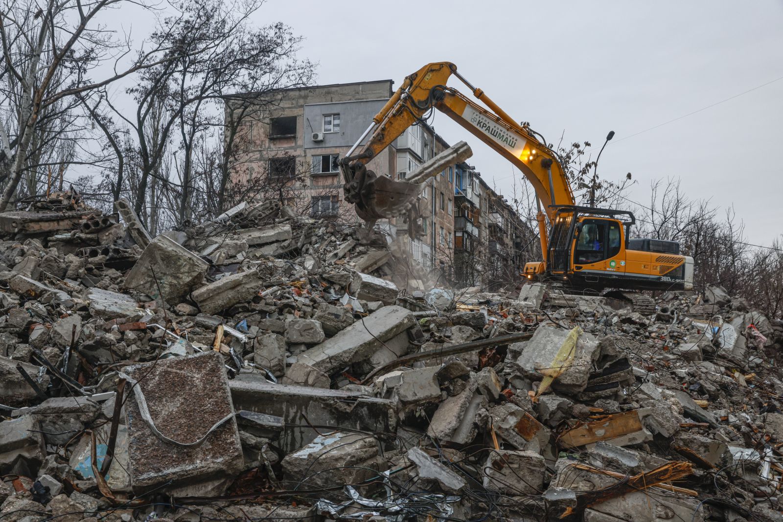 epa10362469 An excavator cleans debris of a destroyed building in downtown of Mariupol, Ukraine, 12 December 2022. Mariupol had seen a long battle for its control between the Ukrainian forces and the Russian army and Russian backed separatist Donetsk People’s Republic (DPR) as well as a siege, the hostilities lasted from February to the end of May 2022 killing thousands of people and destroying most of the city in the process. According to the DPR government which took control after May 2022, more than five thousand builders are currently working in Mariupol, they expect the city to be completely rebuilt in three years' time.  EPA/SERGEI ILNITSKY
