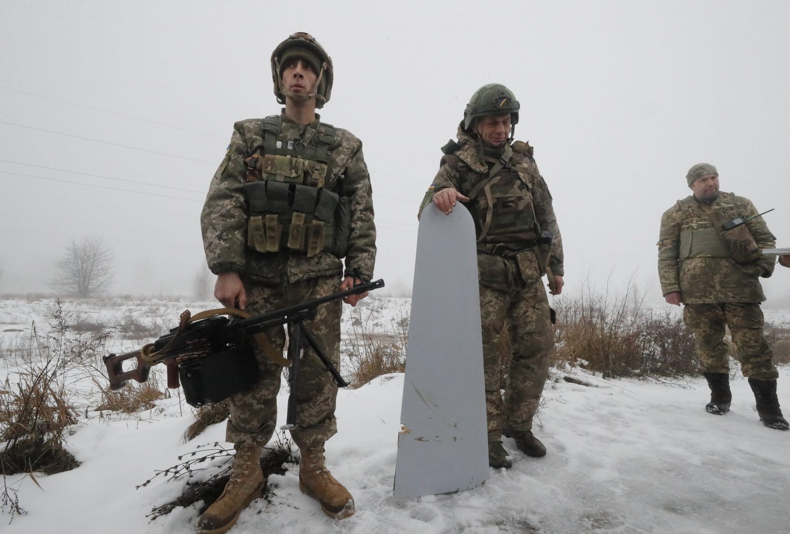 epa10369883 Territorial Defense soldier Oleg Vasylyshyn (L) with his machinegun with which he shot down a Russian rocket Friday, on the outskirts of Kyiv (Kiev), Ukraine, 17 December 2022. According to the Kyiv Military Administration, about 40 missiles were recorded yesterday in the Ukrainian capital's airspace, 37 of which were shot down. A wave of Russian missile attacks on 16 December targeted the Ukrainian capital Kyiv and other parts of the country. Russian troops on 24 February entered Ukrainian territory, starting a conflict that has provoked destruction and a humanitarian crisis.  EPA/SERGEY DOLZHENKO