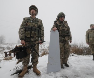 epa10369883 Territorial Defense soldier Oleg Vasylyshyn (L) with his machinegun with which he shot down a Russian rocket Friday, on the outskirts of Kyiv (Kiev), Ukraine, 17 December 2022. According to the Kyiv Military Administration, about 40 missiles were recorded yesterday in the Ukrainian capital's airspace, 37 of which were shot down. A wave of Russian missile attacks on 16 December targeted the Ukrainian capital Kyiv and other parts of the country. Russian troops on 24 February entered Ukrainian territory, starting a conflict that has provoked destruction and a humanitarian crisis.  EPA/SERGEY DOLZHENKO