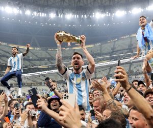 epaselect epa10373170 Lionel Messi of Argentina (C) lifts the trophy as he celebrates with teammates and fans winning  the FIFA World Cup 2022 Final between Argentina and France at Lusail stadium, Lusail, Qatar, 18 December 2022.  EPA/Tolga Bozoglu