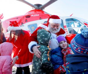 epa10374836 A Santa and his helper, who just landed with an emergency rescue helicopter, are welcomed by children before they attend a Christmas Tree show dedicated to the children of emergency rescue staff at the Interior Ministry Aviation Center in Bucharest, Romania, 20 December 2022. Children of firefighters, emergency rescuers, pilots and other staff of the Romanian Ministry of the Interior (MAI) received gifts from Santa at an event organized in the hangar that houses the helicopters, after Santa was dropped at the location by a rescue helicopter. Romania, an Orthodox Christian country, celebrates Christmas on 25 December. SMURD is an emergency rescue service based in Romania (Mobile Emergency Service for Resuscitation and Extrication), created in 1990.  EPA/ROBERT GHEMENT