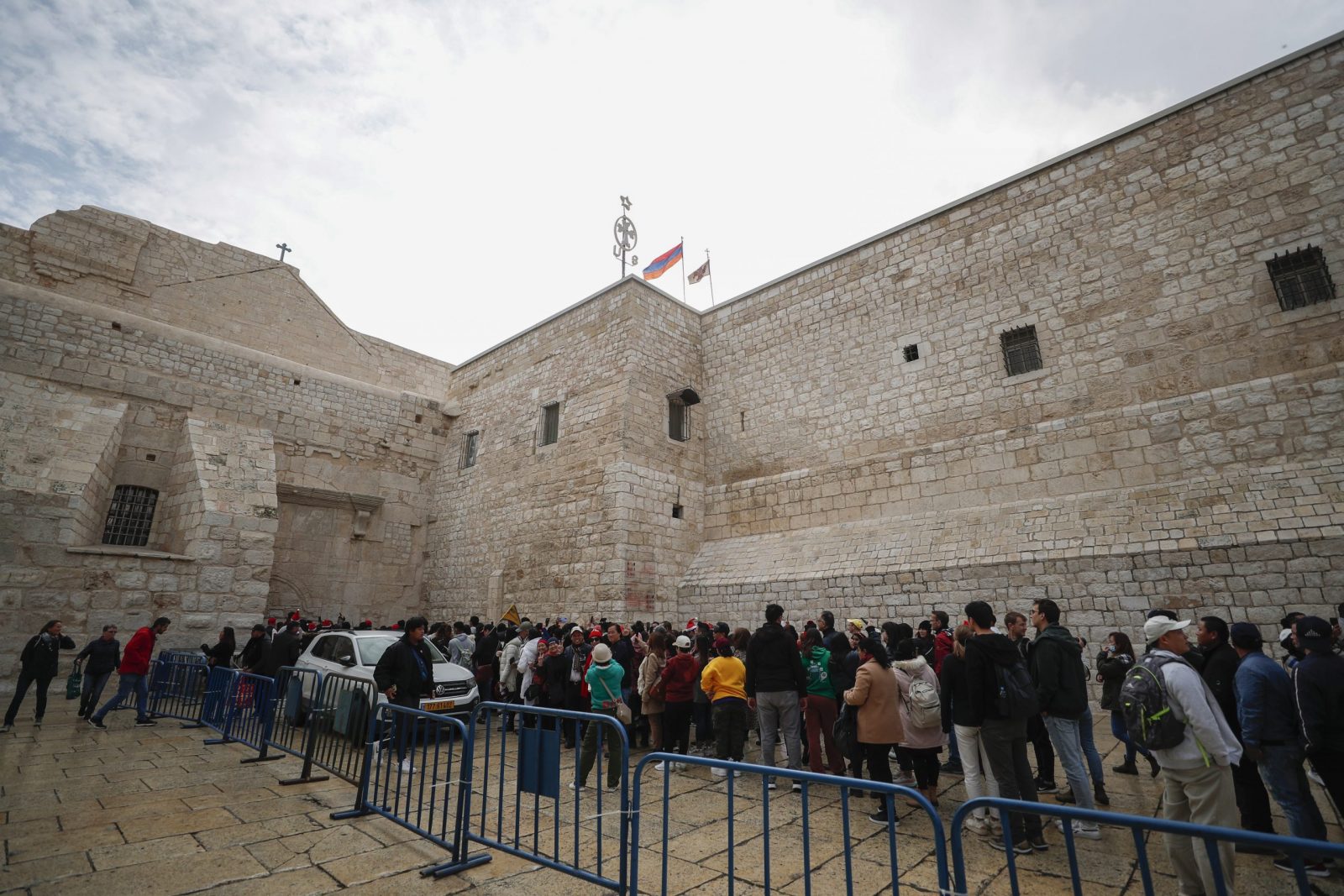 epa10377475 Christian pilgrims wait in line at the  Church of Nativity on Christmas eve, in the West Bank city of Bethlehem, 24 December 2022. The Church of the Nativity is one of the oldest continuously operating churches worldwide. The structure is built over the cave that tradition marks as the birthplace of Christ, and it is considered sacred by followers of Christianity.  EPA/ATEF SAFADI