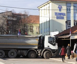 epa10381398 Residents walk past trucks blocking the road in the northern part of Mitrovica, Kosovo, 29 December 2022. Serbian President Aleksandar Vucic declared that ethnic Serbs will start removing barricades blocking roads in the north of Kosovo since 11 December 2022, in a move that deescalates tensions that triggered fears of new clashes in the troubled region.  EPA/STR