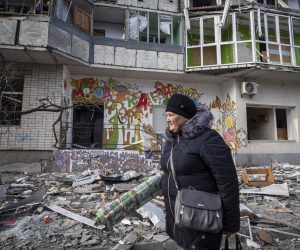 epa10375640 A resident passes a destroyed residential building following overnight shelling in Kherson, Ukraine, 21 December 2022. Ukrainian troops entered Kherson on 11 November after the Russian army had withdrawn from the city which they captured in the early stage of the conflict, shortly after Russian troops had entered Ukraine in February 2022. The Ukrainian president accused the Russian army of deliberately destroying critical infrastructure during their withdrawal from the city of Kherson, including electricity and water supplies.  EPA/Maria Senovilla