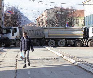 epa10381399 A resident walks past trucks blocking the road in the northern part of Mitrovica, Kosovo, 29 December 2022. Serbian President Aleksandar Vucic declared that ethnic Serbs will start removing barricades blocking roads in the north of Kosovo since 11 December 2022, in a move that deescalates tensions that triggered fears of new clashes in the troubled region.  EPA/STR