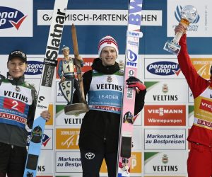 epa10385572 (L-R) second placed Anze Lanisek of Slovenia, winner Halvor Egner Granerud of Norway and  third placed Dawid Kubacki of Poland celebrate on the podium for the second stage of the 71st Four Hills Ski Jumping Tournament in Garmisch Partenkirchen, Germany, 01 January 2023.  EPA/CHRISTIAN BRUNA