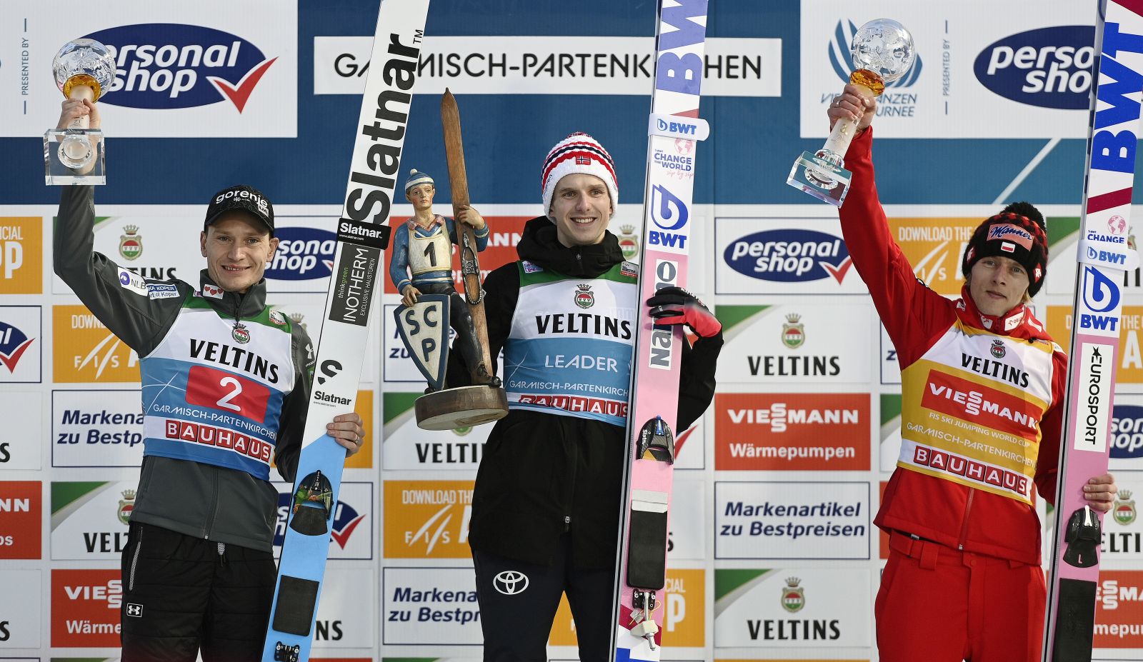 epa10385572 (L-R) second placed Anze Lanisek of Slovenia, winner Halvor Egner Granerud of Norway and  third placed Dawid Kubacki of Poland celebrate on the podium for the second stage of the 71st Four Hills Ski Jumping Tournament in Garmisch Partenkirchen, Germany, 01 January 2023.  EPA/CHRISTIAN BRUNA