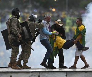 epa10396412 Police confront supporters of former Brazilian President Jair Bolsonaro invading Planalto Palace, in Brasilia, Brazil, 08 January 2023. Hundreds of supporters of former Brazilian President Jair Bolsonaro invaded the headquarters of the National Congress, and also Supreme Court and the Planalto Palace, seat of the Presidency of the Republic, in a demonstration calling for a military intervention to overthrow President Luiz Inacio Lula da Silva. The crowd broke through the cordons of security forces and forced their way to the roof of the buildings of the Chamber of Deputies and the Senate, and some entered inside the legislative headquarters.  EPA/ANDRE BORGES
