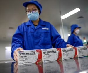 epa10398011 Workers prepare to pack anti-fever tablets at the Youcare Pharmaceutical Group office during a government-organized media tour in Beijing, China, 10 January 2023. Chinese officials have said that most of the country's populous areas have reached the peak of the COVID-19 as cases have been declining in Beijing and several provinces.  EPA/MARK R. CRISTINO