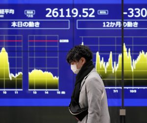 epa10402935 A passerby walks in front of a stock market indicator board in Tokyo, Japan, 13 January 2023. The Nikkei Stock Average ended down 330.30 points, or 1.25 percent, to close the week at 26,119.52 as the yen hit a seven-month high against the US dollar earlier in the day.  EPA/FRANCK ROBICHON