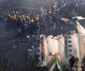 epa10406959 Rescue teams working near the wreckage at the crash site of a Yeti Airlines ATR72 aircraft in Pokhara, central Nepal, 15 January 2023. A Yeti Airlines ATR72 aircraft carrying 72 people on board, 68 passengers and 4 crew members, crashed into a gorge while trying to land at the Pokhara International Airport. According to a statement from the Civil Aviation Authority of Nepal (CAAN), at least 68 people were confirmed dead.  EPA/KRISHNA MANI BARAL