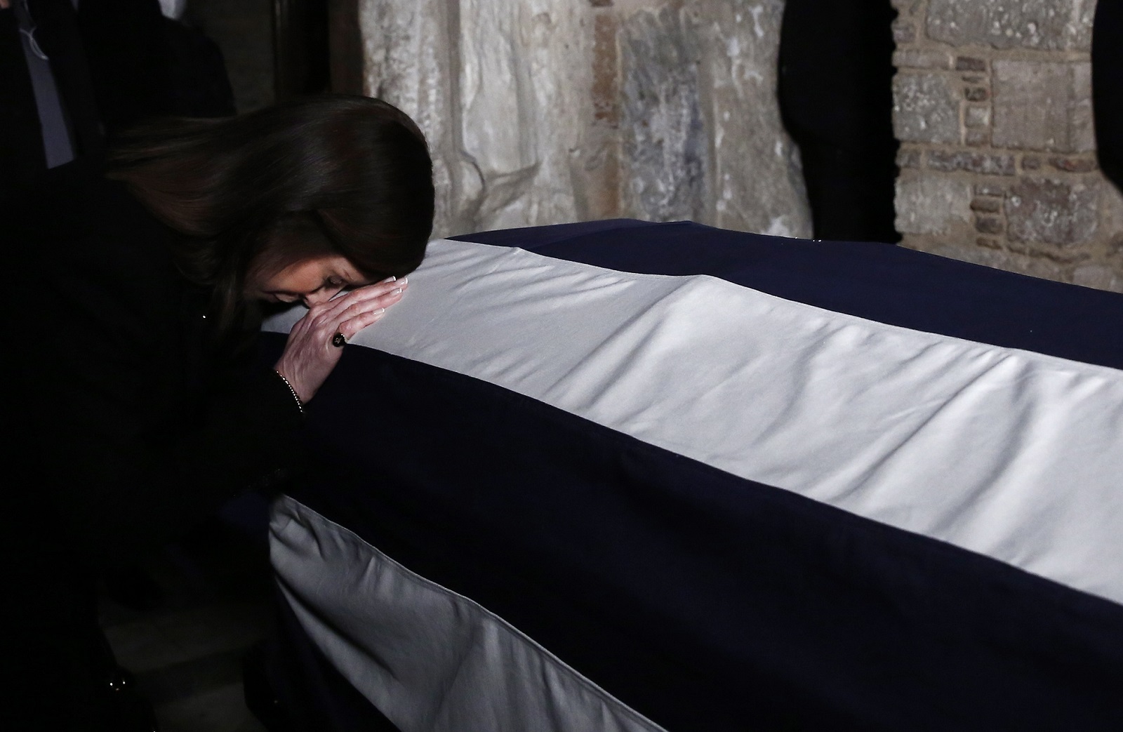 epa10408350 A woman pays her respects to the former King Constantine II, at Saint Eleftherios chapel of the Metropolis Ctahedral in Athens, Greece, 16 January 2023. Greece's former King Constantine II died at the age of 82 on 10 January 2023. The funeral service is due to take place at the Metropolis Cathedral of Athen and he will be burried near the graves of his ancestrors at the Tatoi former royal palace.  EPA/YANNIS KOLESIDID