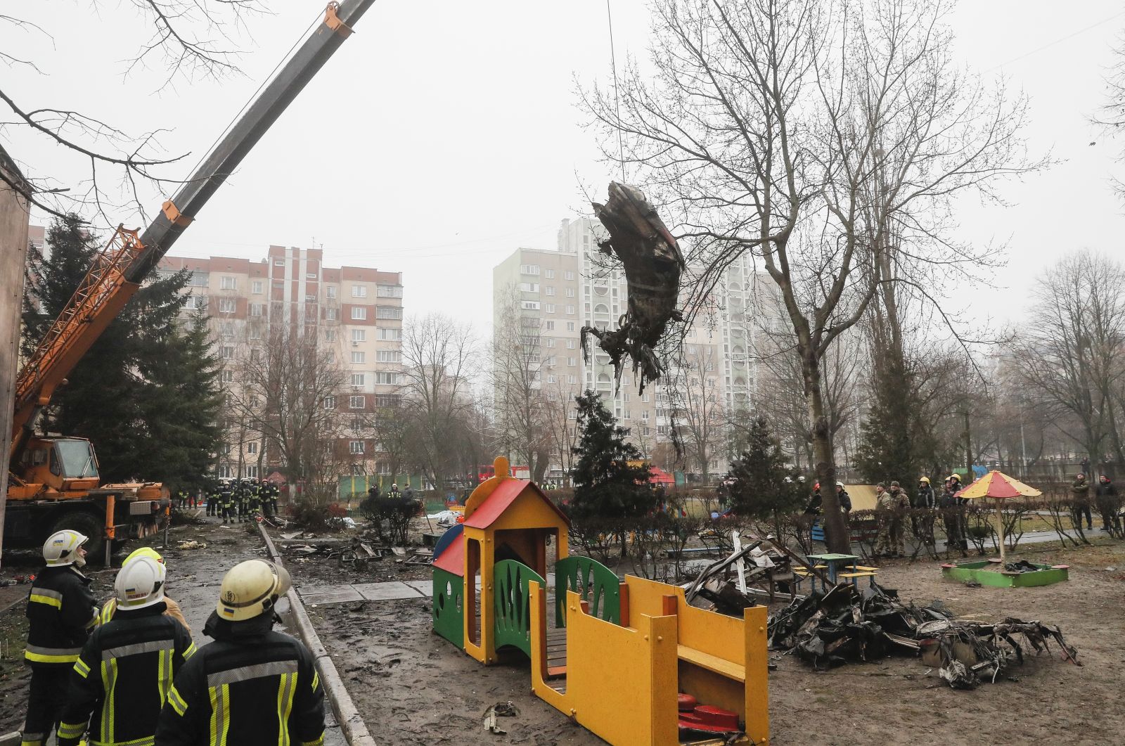 epa10413087 Rescue services remove debris of the helicopter at the scene of a helicopter crash in Brovary, near Kyiv, Ukraine, 18 January 2023. At least 18 people died, including three children, after a helicopter crashed near a kindergarten and a residential building in the city of Brovary, Oleksiy Kuleba, the head of Kyiv Regional Military Administration wrote on telegram. 'Among them are Minister of Internal Affairs of Ukraine Denys Monastyrskyi, his first deputy Yevhen Yenin, State Secretary of the Ministry of Internal Affairs Yuri Lubkovych, their assistants and the helicopter crew.', stated President of Ukraine Volodymyr Zelensky.  EPA/SERGEY DOLZHENKO