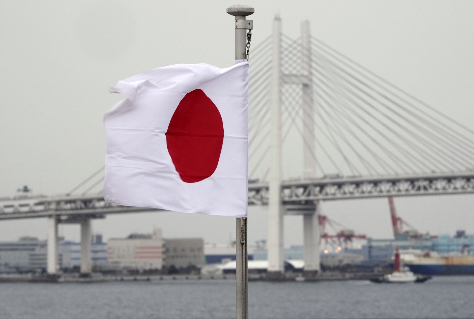 epa10415094 A Japanese national flag waves at a port in Yokohama, near Tokyo, Japan, 19 January 2023. According to data released by the Ministry of Finance, Japan recorded a trade deficit of 19.97 trillion yen (143,8 billion euros) in 2022. It is the largest annual deficit since 1979, when comparable data were available, due to soaring energy prices while the depreciation of the yen increased the amount of imports.  EPA/FRANCK ROBICHON