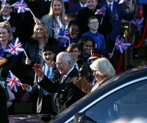 epa10418057 Britain's King Charles III (L) and Camilla, The Queen Consort (R) wave as they arrive at Bolton Town Hall in Bolton, Britain, 20 January 2023. The royal couple will meet representatives from the community in Bolton including Bolton Asian Elders, Bolton’s Polish community and the Association of Ukrainians in Great Britain.  EPA/ADAM VAUGHAN