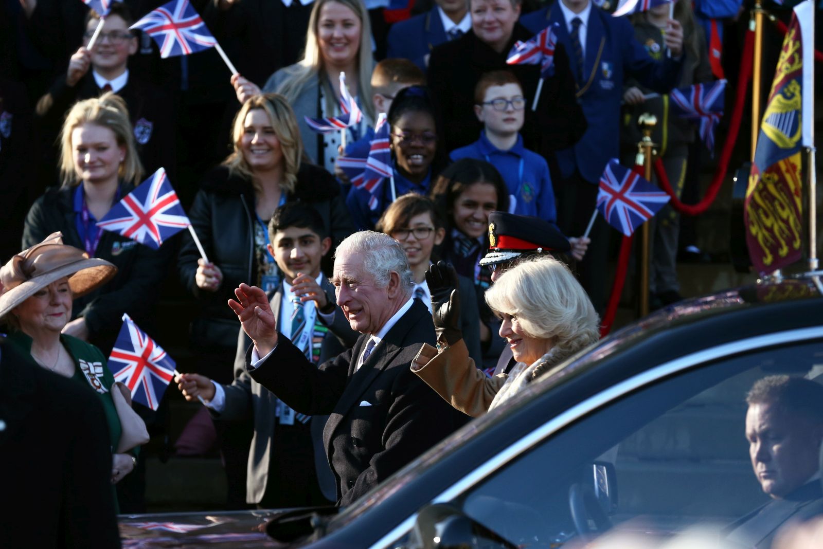 epa10418057 Britain's King Charles III (L) and Camilla, The Queen Consort (R) wave as they arrive at Bolton Town Hall in Bolton, Britain, 20 January 2023. The royal couple will meet representatives from the community in Bolton including Bolton Asian Elders, Bolton’s Polish community and the Association of Ukrainians in Great Britain.  EPA/ADAM VAUGHAN
