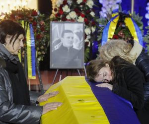 epa10420633 Relatives and friends pay their respects during a funeral ceremony for victims of the 18 January helicopter crash, in Kyiv, Ukraine, 21 January 2023. At least 14 people died in a helicopter crash in Brovary on 18 January 2023, among them Internal Affairs minister Denys Monastyrskyi, his first deputy Yevhen Yenin, and State Secretary of the Ministry of Internal Affairs Yuri Lubkovych.  EPA/SERGEY DOLZHENKO