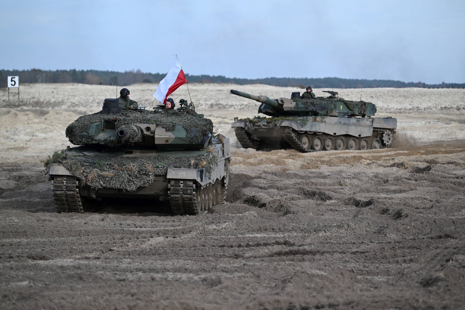 epa10424671 (FILE) - Polish 'Leopard 2'  tanks during the maneuvers of the Visegrad Group countries, the United States and the United Kingdom ph. 'PUMA 22' at the training ground in Nowa Deba, southeast Poland, 09 November 2022 (reissued 23 January 2023). During a tour through the country, Polish Prime Minister Mateusz Morawiecki announced in Poznan on 23 January 2023, that Poland will 'formally ask Germany for permission to hand over some of its German-made Leopard 2 tanks to Ukraine', the Polish news agency PAP reported.  EPA/Darek Delmanowicz  POLAND OUT