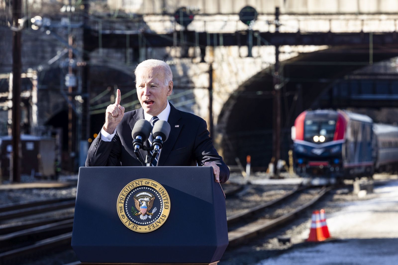 epa10440479 US president Joe Biden speaks about the infrastructure bill next to Amtrak's 150-year old Baltimore and Potomac Tunnel in Baltimore, Maryland, USA, 30 January 2023. The aging tunnel is reportedly the largest bottleneck for rail commuters on Amtrak's Northeast Corridor.  EPA/JIM LO SCALZO