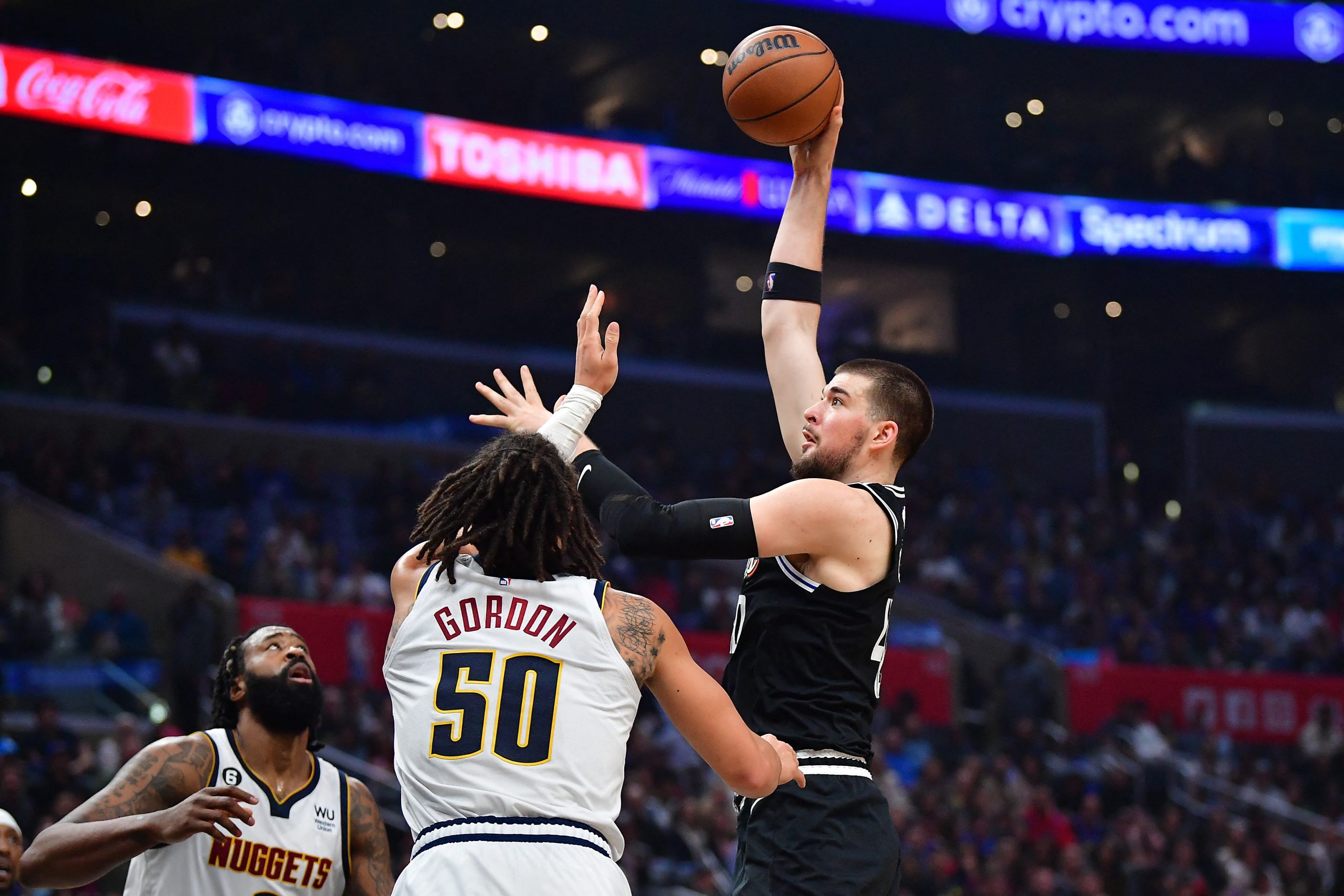 January 13, 2023; Los Angeles, California, USA; Los Angeles Clippers center Ivica Zubac (40) shoots against Denver Nuggets forward Aaron Gordon (50) during the first half at Crypto.com Arena. Mandatory Credit: Gary A. Vasquez-USA TODAY Sports Photo: Gary A. Vasquez/REUTERS