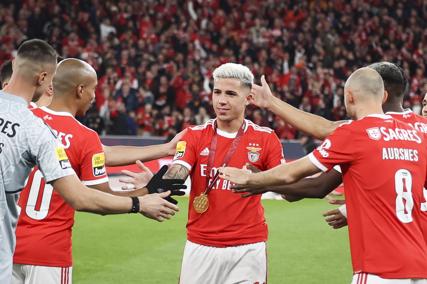 epa10407533 SL Benfica's player Enzo Fernandez is greeted by is teammates after receiving a medal of honor after winning the Qatar World Cup with Argentina, before the Portuguese Primeira Liga soccer match between SL Benfica and Sporting CP, in Lisbon, Portugal, 15 January 2023.  EPA/JOSE SENA GOULAO