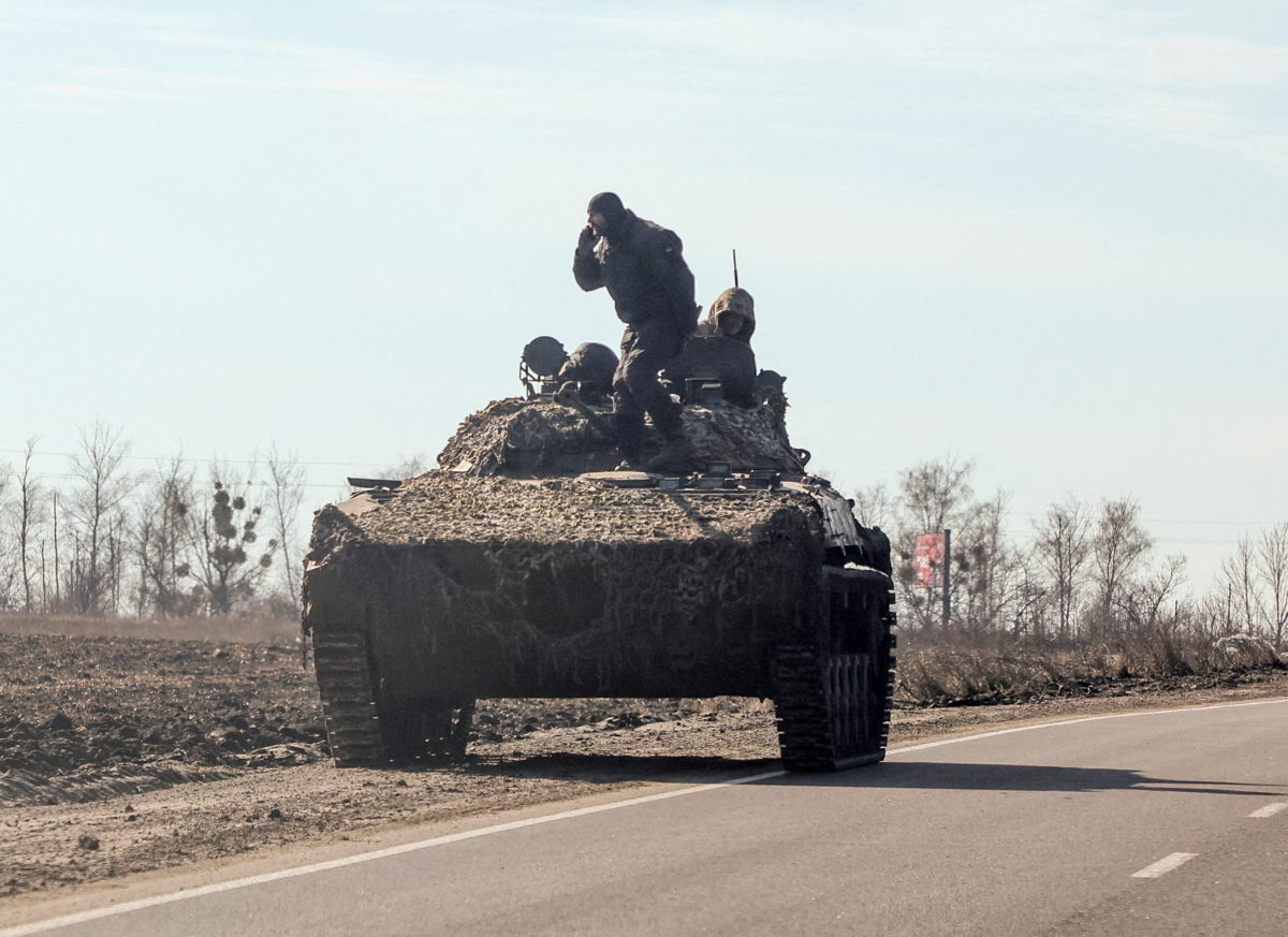 Ukrainian army soldiers are seen on an armoured vehicle, after Russian President Vladimir Putin authorised a military operation, in eastern Ukraine, in Kharkiv region, Ukraine February 24, 2022. REUTERS/Antonio Bronic