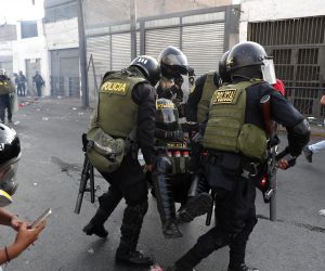 epa10416730 Police officers assist a colleague during a confrontation with demonstrators during the 'Takeover of Lima' protest in Lima, Peru, 19 January 2023. The great national march called 'Takeover of Lima' has triggered a series of protest actions in different parts of the country. The protesters demand the resignation of Boluarte and the closure of Congress, as well as the calling of general elections for this year and a constituent assembly.  EPA/Paolo Aguilar