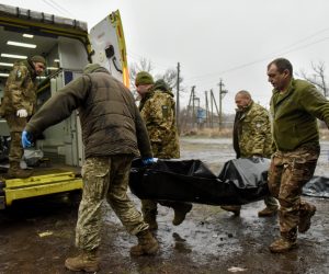 epa10438860 Combat medics carry the remains of a Ukranian soldier in the Donetsk region, eastern Ukraine, 29 January 2023. Russian troops entered Ukraine on 24 February resulting in fighting and destruction in the country and triggering a series of severe economic sanctions on Russia by Western countries.  EPA/OLEG PETRASYUK
