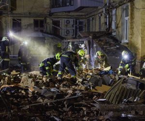 epa10439906 Ukrainian rescuers work on a residential building hit in Russian overnight shelling in Kharkiv, Ukraine, 30 January 2023. At least one woman was killed and three people were injured in the shelling, according to the Ukrainian Emergency Service. Kharkiv and surrounding areas have been the target of heavy shelling since February 2022, when Russian troops entered Ukraine territory starting an armed conflict that has provoked destruction and a humanitarian crisis.  EPA/SERGEY KOZLOV