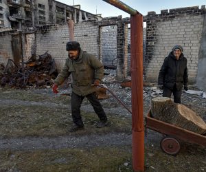 epa10431486 Serhiy pulls a wheelbarrow with wood near his apartment blocks  in retaken town Lyman Donetsk region, eastern Ukraine, 26 January 2023.
Lyman was re-captured by Ukraine armed forces in October.  Before the beginning of active combat action population of Lyman was around 41000. After being under Russian occupation, without electricity, water and gas supply, infrastructure is slowly renewing. Russian troops entered Ukraine on 24 February resulting in fighting and destruction in the country and triggering a series of severe economic sanctions on Russia by Western countries.  EPA/OLEG PETRASYUK