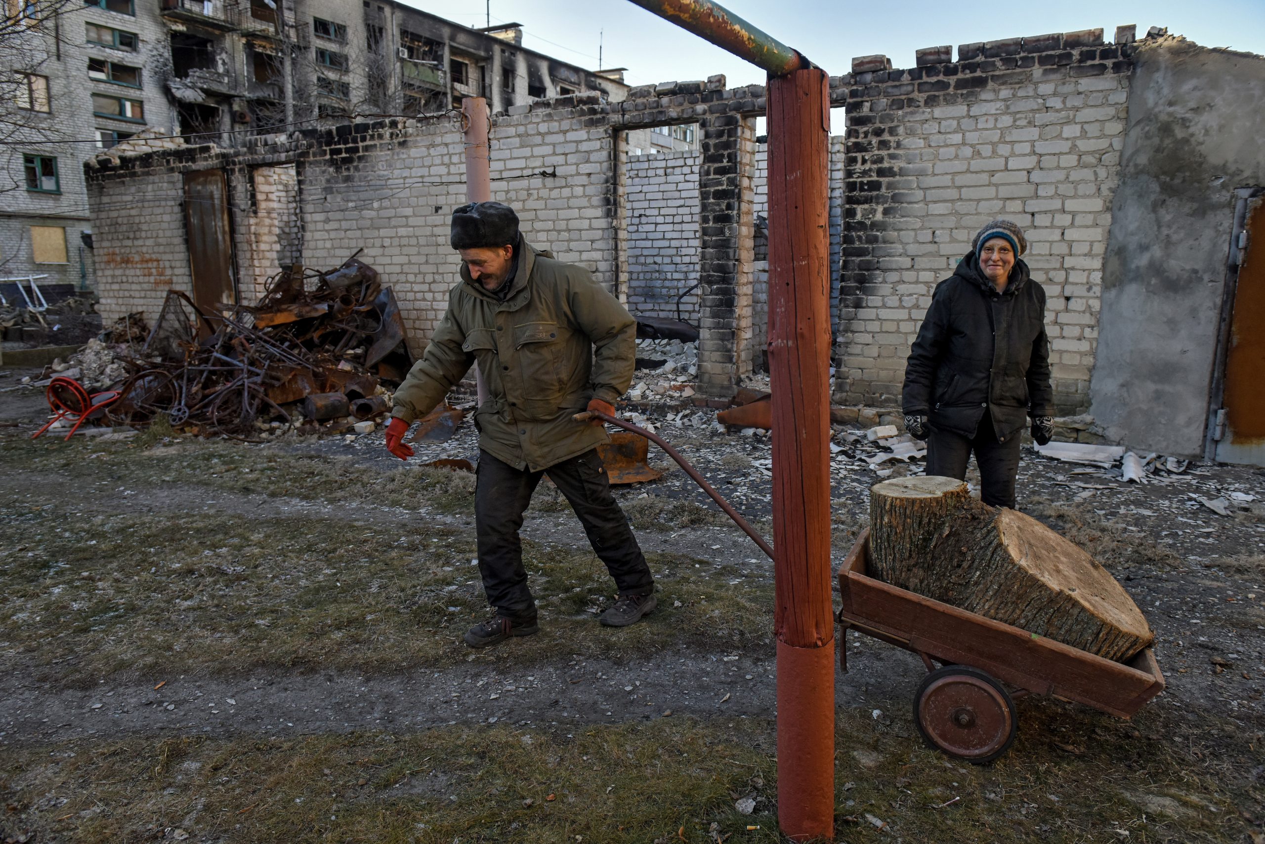 epa10431486 Serhiy pulls a wheelbarrow with wood near his apartment blocks  in retaken town Lyman Donetsk region, eastern Ukraine, 26 January 2023.
Lyman was re-captured by Ukraine armed forces in October.  Before the beginning of active combat action population of Lyman was around 41000. After being under Russian occupation, without electricity, water and gas supply, infrastructure is slowly renewing. Russian troops entered Ukraine on 24 February resulting in fighting and destruction in the country and triggering a series of severe economic sanctions on Russia by Western countries.  EPA/OLEG PETRASYUK