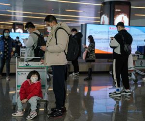 epa10412499 Passengers wearing face masks walk with their luggage at Nanning Wuxu International Airport in Nanning, Guangxi Zhuang Autonomous Region, China, 18 January 2023. Chinese passengers are traveling domestically as the country’s most important holiday season kicked off, after the lifting of its zero-Covid policy. Some 34 million trips across the country were made by road, railway, water or air on 07 January alone, the first day of the Lunar New Year travel rush, according to the data released by the Ministry of Transport.  EPA/WU HAO