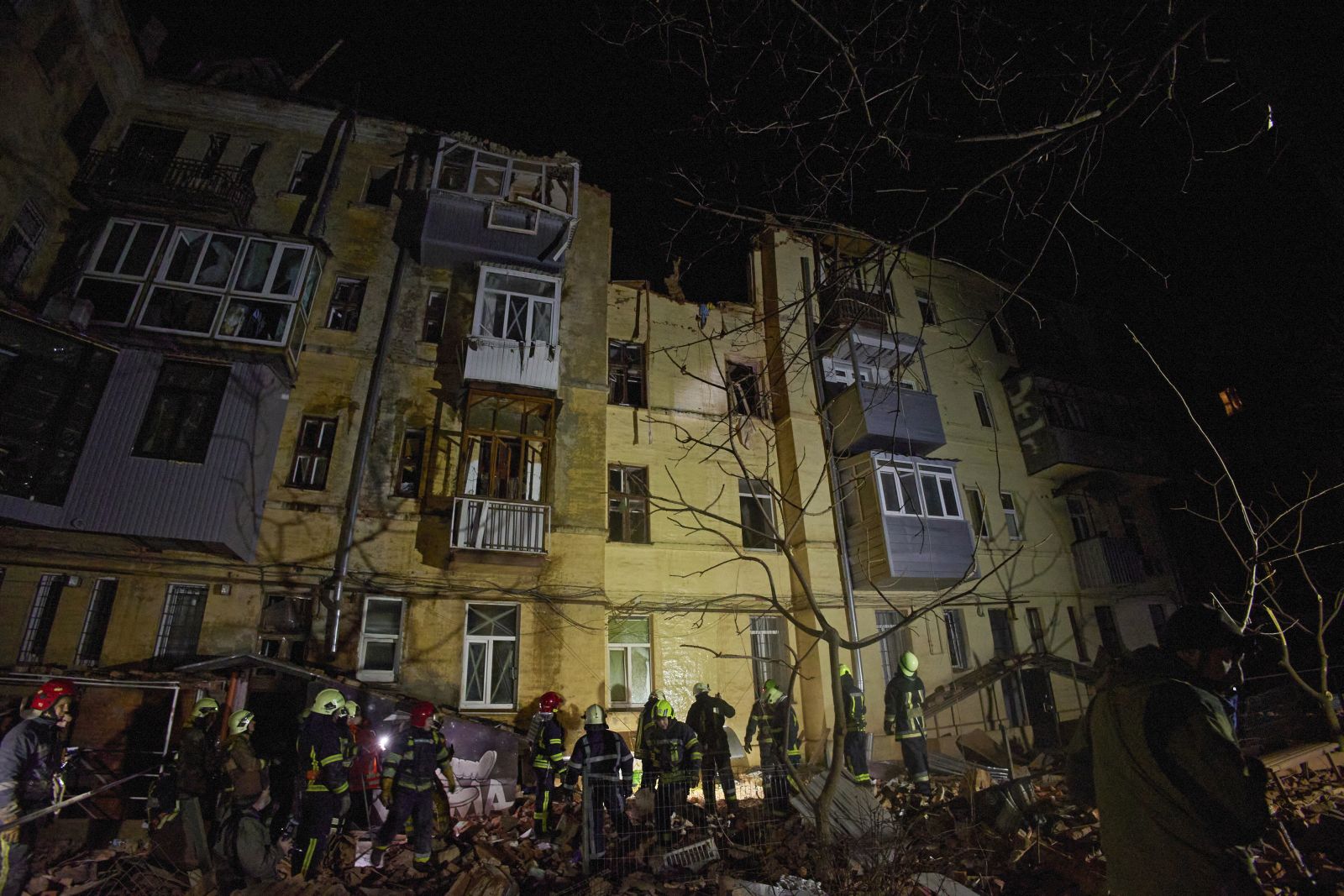 epa10439913 Ukrainian rescuers work on a residential building hit in Russian overnight shelling in Kharkiv, Ukraine, 30 January 2023. At least one woman was killed and three people were injured in the shelling, according to the Ukrainian Emergency Service. Kharkiv and surrounding areas have been the target of heavy shelling since February 2022, when Russian troops entered Ukraine territory starting an armed conflict that has provoked destruction and a humanitarian crisis.  EPA/SERGEY KOZLOV