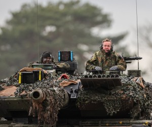 epa10442779 German Defense Minister Boris Pistorius (R) rides on the turret of a 'Leopard 2 A6' battle tank during his visit to German armed forces Bundeswehr soldiers of the tank battalion 203 in Augustdorf, Germany, 01 February 2023. According to the German government's decision to supply 14 Leopard 2 tanks to Ukraine, Pistorius got informed about the performance of the weapon system.  EPA/FRIEDEMANN VOGEL