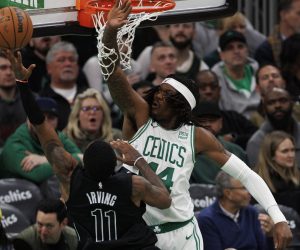 epa10443642 Boston Celtics center Robert Williams III (R) blocks the shot of Brooklyn Nets guard Kyrie Irving (L) during the second half at TD Garden in Boston, Massachusetts, USA, 01 February 2023.  EPA/CJ GUNTHER  SHUTTERSTOCK OUT