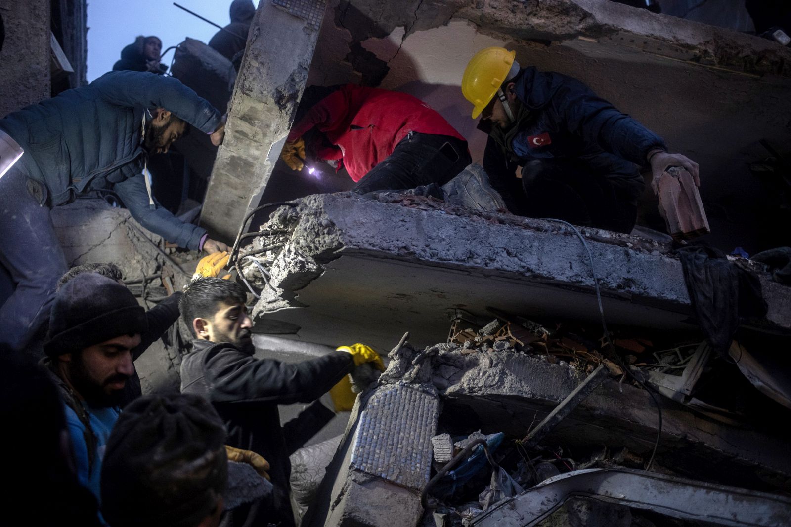 epa10450297 Turkish emergency personnel and others try to help victims at the site of a collapsed building after an earthquake in Diyarbakir, Turkey, 06 February 2023. According to the US Geological Service, an earthquake with a preliminary magnitude of 7.8 struck southeast Turkey close to the Syrian border. The earthquake caused buildings to collapse and sent shockwaves over northwest Syria, Cyprus, and Lebanon.  EPA/REFIK TEKIN