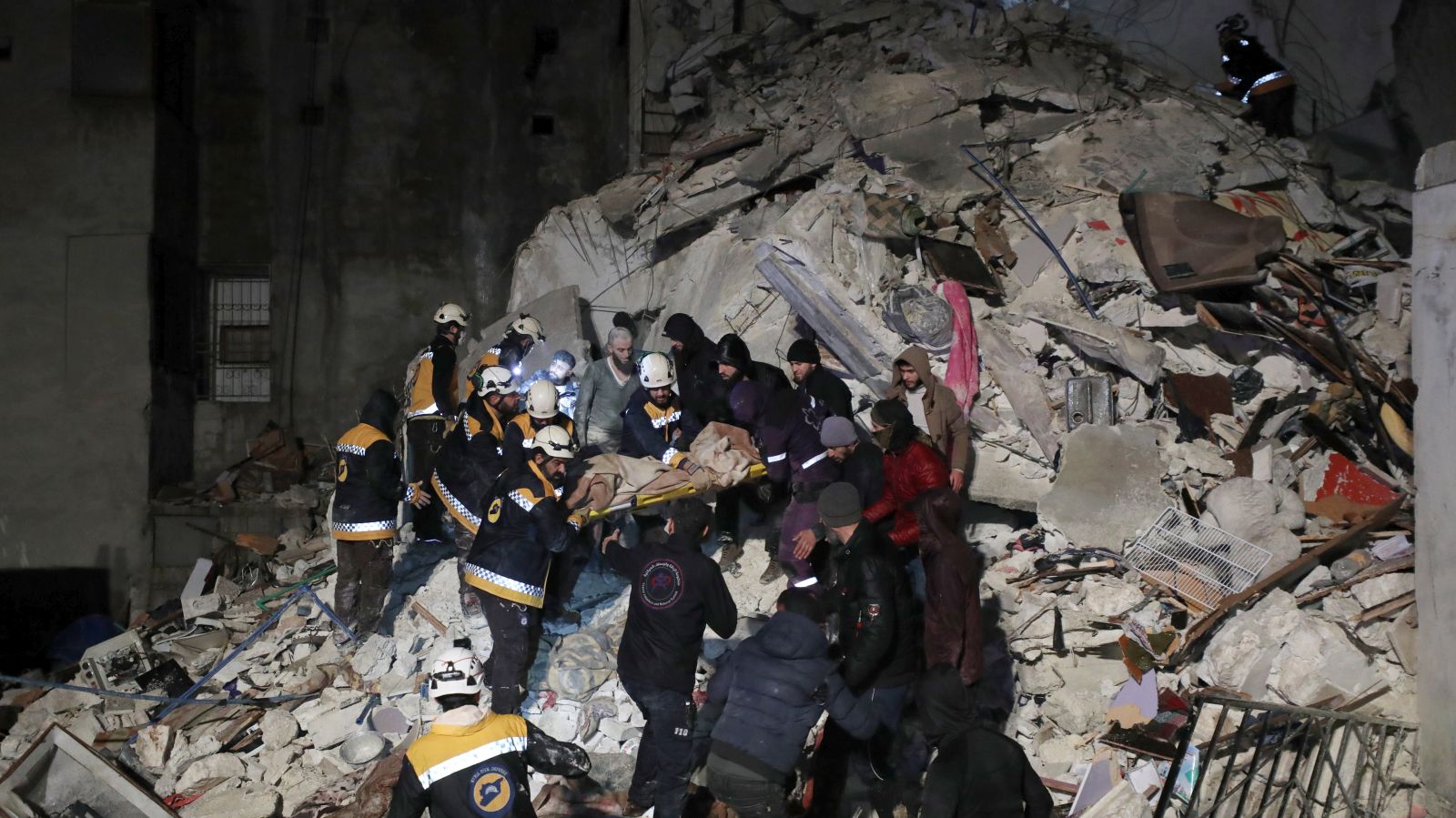 epa10450683 Rescuers search the rubble of a building for survivors following an earthquake in Idlib province, Syria 06 February 2023. According to the US Geological Service, an earthquake with a preliminary magnitude of 7.8 struck southern Turkey close to the Syrian border, causing buildings to collapse and sending shockwaves over northwest Syria, Cyprus, and Lebanon. At least 221 people were killed and 419 injured in northwest Syria, with hundreds remaining trapped under the rubble, according to the White Helmets group, the Syria Civil Defence operating in the area.  EPA/YAHYA NEMAH
