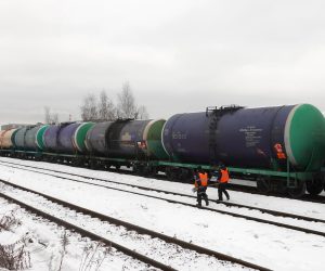 epa10450775 Workers walk in front of railway tankers carrying oil products outside Moscow, Russia, 06 February 2023. On 24 February 2022 Russian troops entered Ukrainian territory in what the Russian president declared a 'Special Military Operation', resulting in multiple sanctions against Russia, including sanctions against the oil industry.  EPA/MAXIM SHIPENKOV