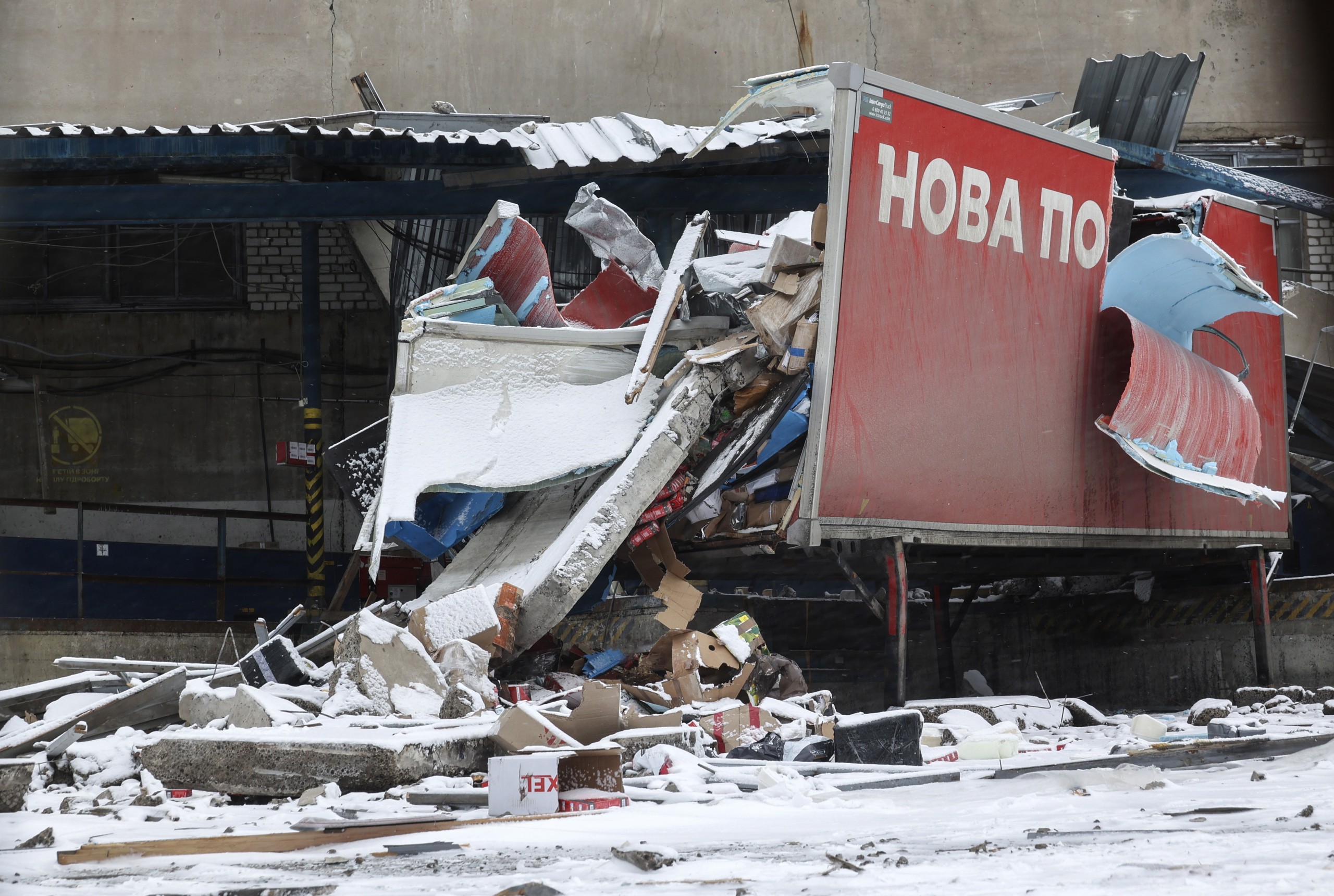 epa10462679 The site of the damaged 'Nova Poshta' postal storehouse following a missile strike, in Kharkiv, northeastern Ukraine, 12 February 2023, amid Russia's invasion. At least one man was injured after Russian missiles hit Kharkiv on 11 February late evening, the head of the Kharkiv regional military administration, said. Kharkiv and surrounding areas have been the target of heavy shelling since February 2022, when Russian troops entered Ukraine starting a conflict that has provoked destruction and a humanitarian crisis.  EPA/SERGEY KOZLOV