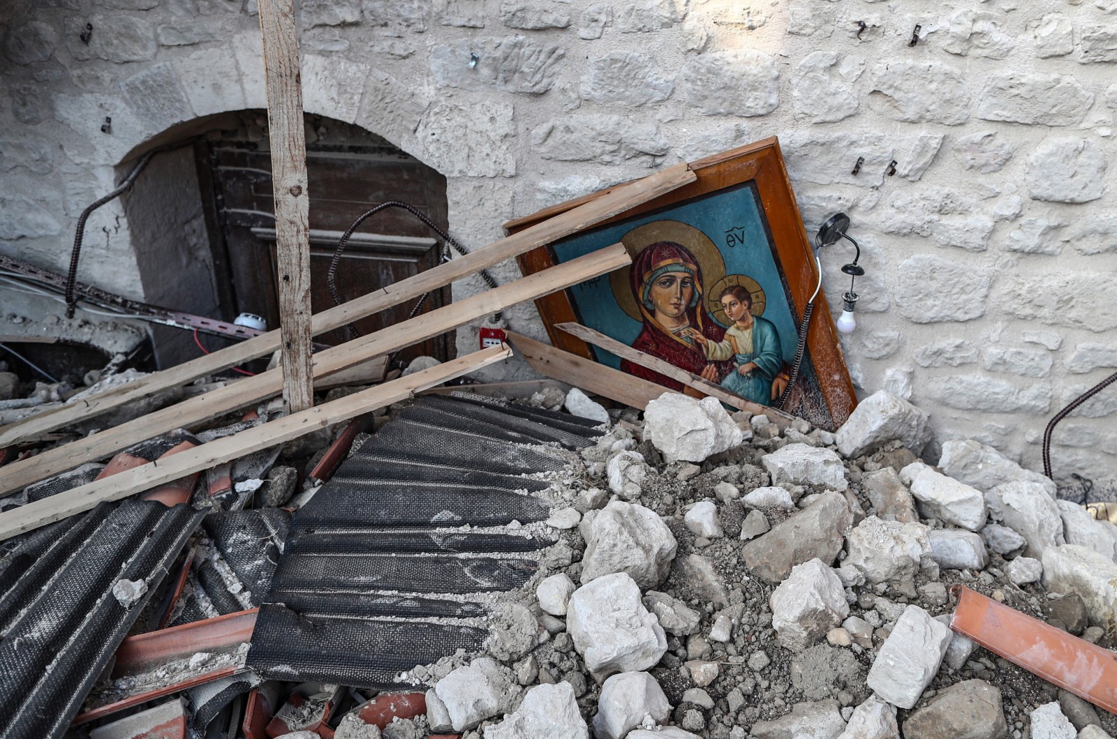 epa10462921 An icon in the rubble of the collapsed Virgin Mary Greek Orthodox Church after an earthquake in Altinozu, district of Hatay, Turkey, 12 February 2023. More than 27,000 people have died and thousands more were injured after two major earthquakes struck southern Turkey and northern Syria on 06 February. Authorities fear the death toll will keep climbing as rescuers look for survivors across the regions.  EPA/ERDEM SAHIN  ATTENTION: This Image is part of a PHOTO SET
