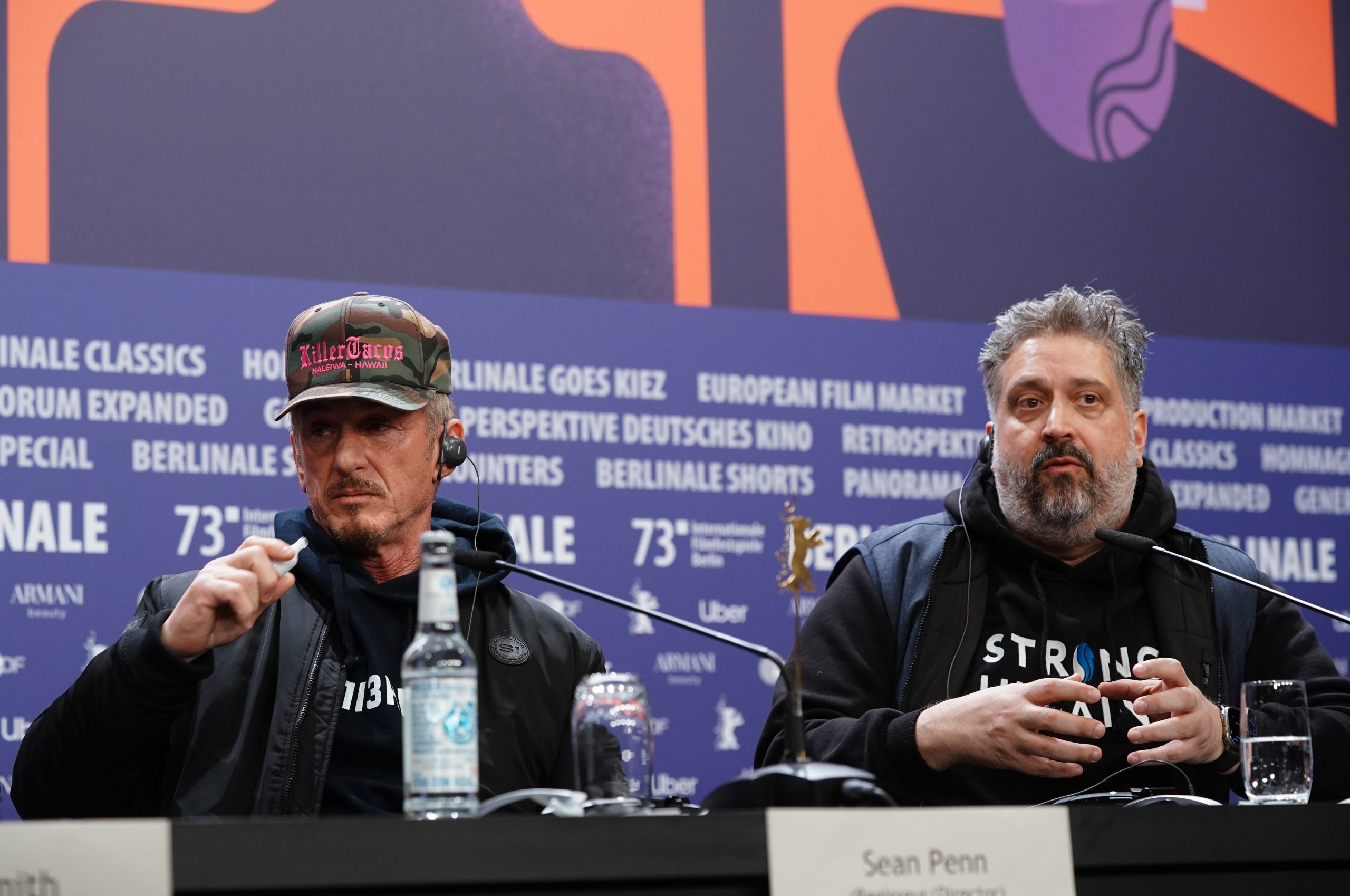 epa10474359 US directors Sean Penn (L) and Aaron Kaufman (R) speak during the press conference for the movie 'Superpower' during the 73rd Berlin International Film Festival 'Berlinale' in Berlin, Germany, 18 February 2023. The in-person event runs from 16 to 26 February 2023.  EPA/CLEMENS BILAN