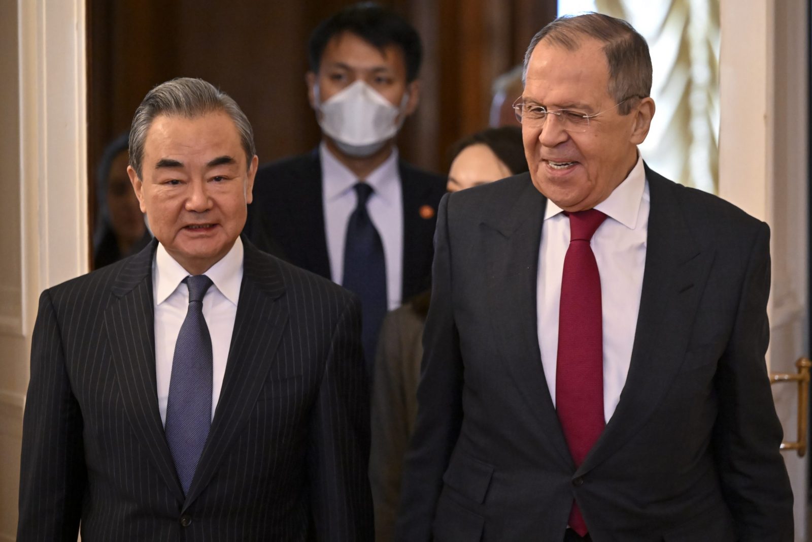epa10483107 Russian Foreign Minister Sergei Lavrov (R) and China's Director of the Office of the Central Foreign Affairs Commission Wang Yi (L) enter a hall during a meeting in Moscow, Russia, 22 February 2023. Wang Yi arrived in Moscow on 21 February, and engaged in negotiations with the Secretary of the Security Council of the Russian Federation Nikolai Patrushev. At this meeting, Wang Yi stressed that Chinese-Russian relations are 'strong as a rock' and 'will stand the test in the changing international situation.' According to Wang Yi, Beijing is ready, together with Moscow, to resolutely defend national interests and promote mutually beneficial cooperation in all areas.  EPA/ALEXANDER NEMENOV / POOL